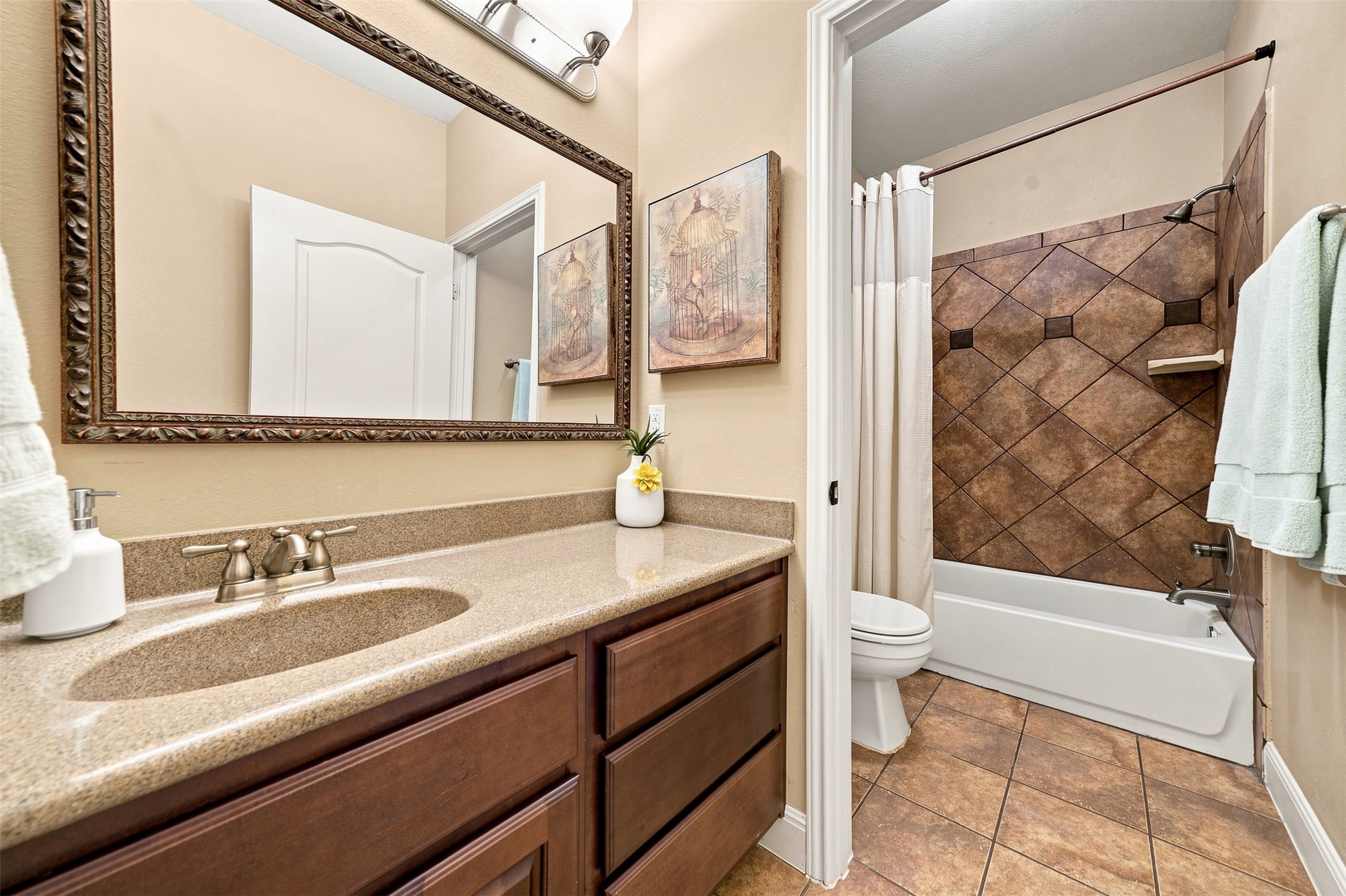 402 Ridgetop Bend Cedar Park, TX 78613 - Photo 28 of 40 A classic bathroom layout includes a stone vanity alongside a tiled shower and tub combination.