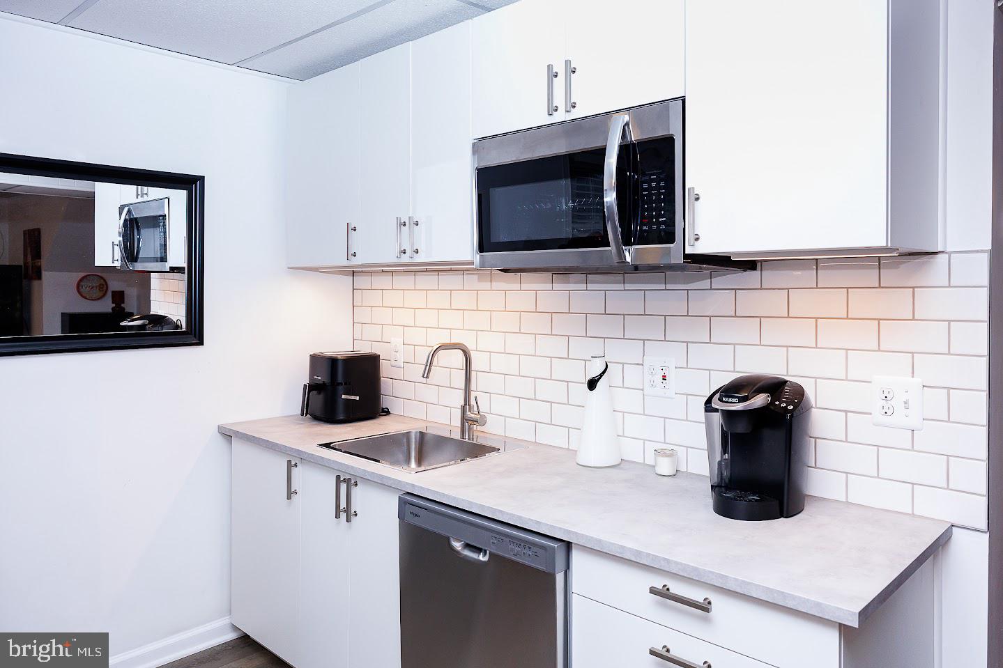 7286 Earlys Road Warrenton, VA 20187 - Photo 12 of 25 a kitchen with a sink a microwave and cabinets
