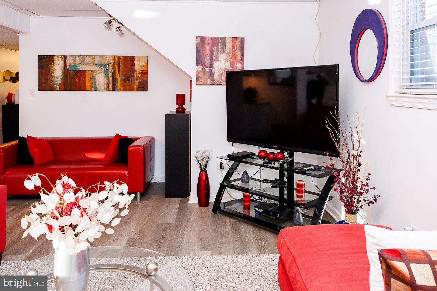 7286 Earlys Road Warrenton, VA 20187 - Photo 16 of 25 a living room with furniture a flat screen tv and a fireplace