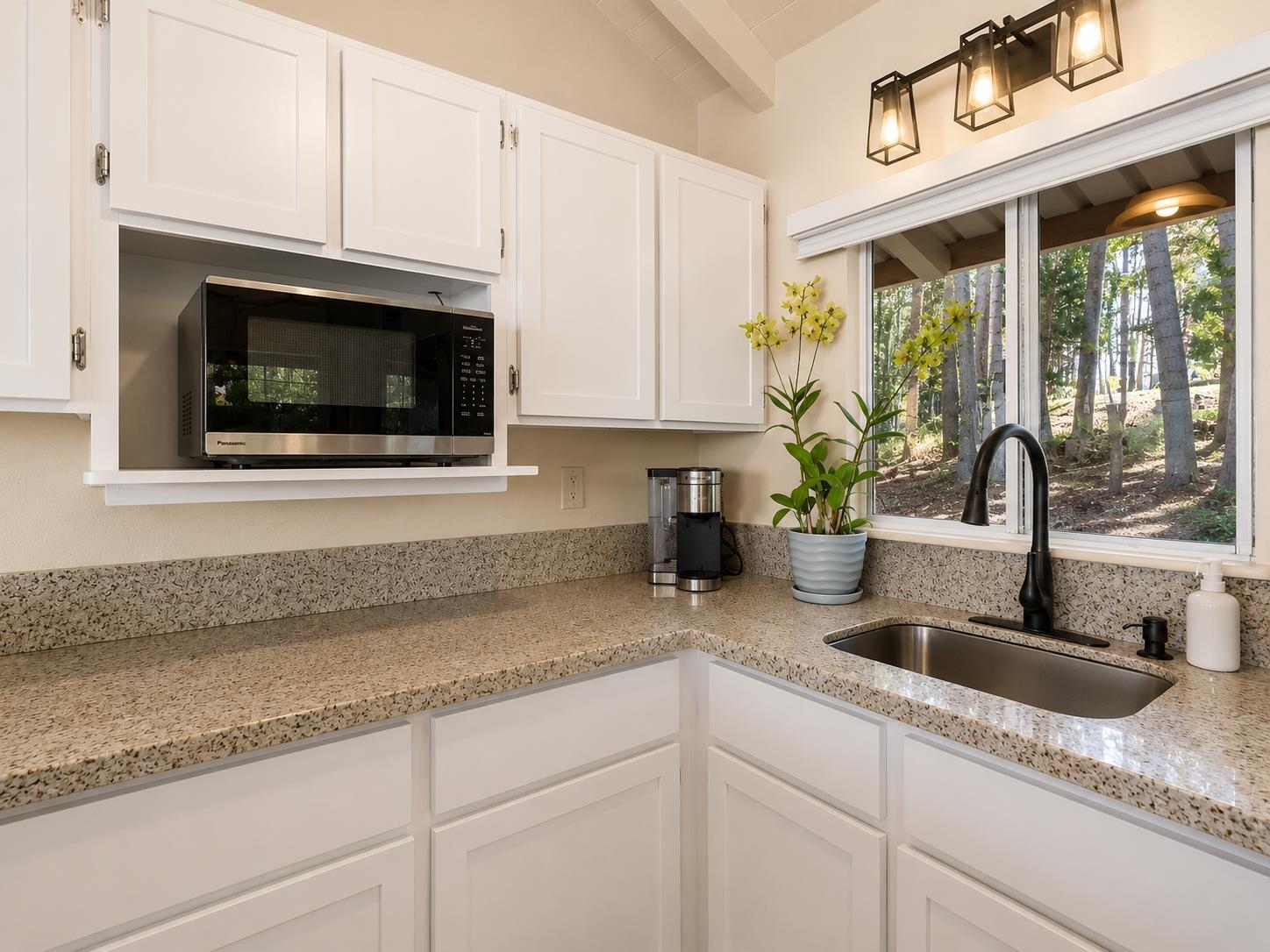 2475 Lilikoi Road Haiku, HI 96708 - Photo 5 of 18 a kitchen with granite countertop a sink stainless steel appliances a counter space and cabinets