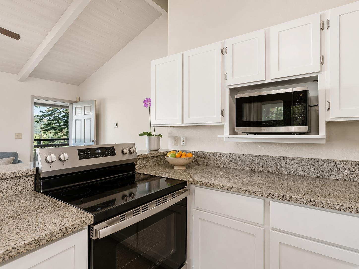 2475 Lilikoi Road Haiku, HI 96708 - Photo 7 of 18 a kitchen with granite countertop a stove microwave and sink