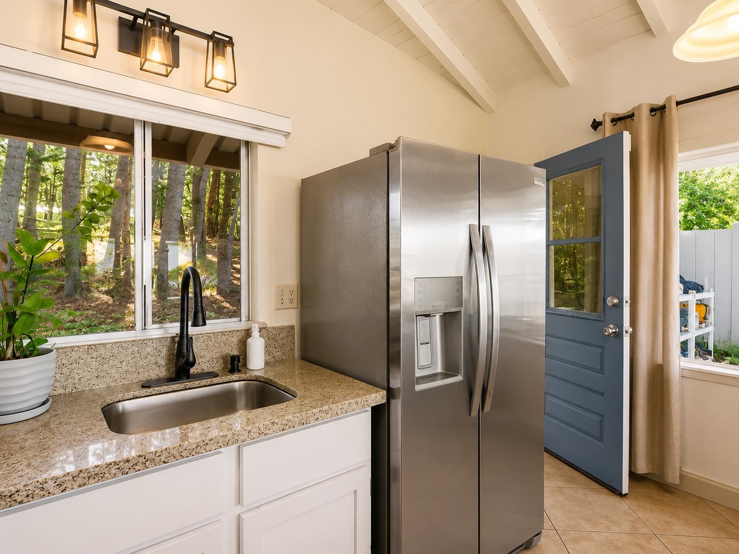 2475 Lilikoi Road Haiku, HI 96708 - Photo 9 of 18 a kitchen with granite countertop a refrigerator and a sink