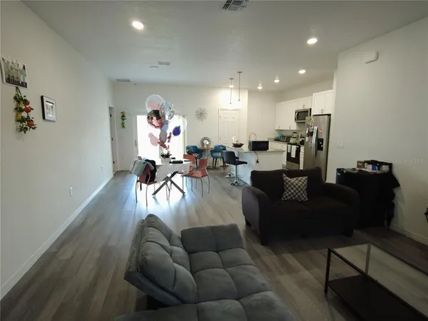 a living room with furniture and a chandelier