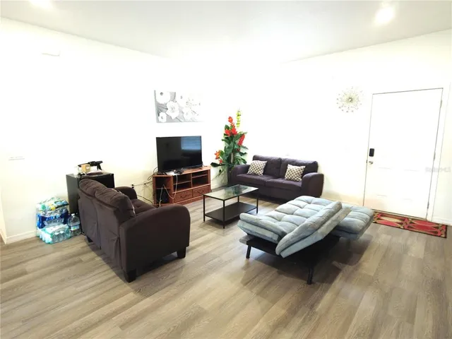 a living room with furniture and a flat screen tv