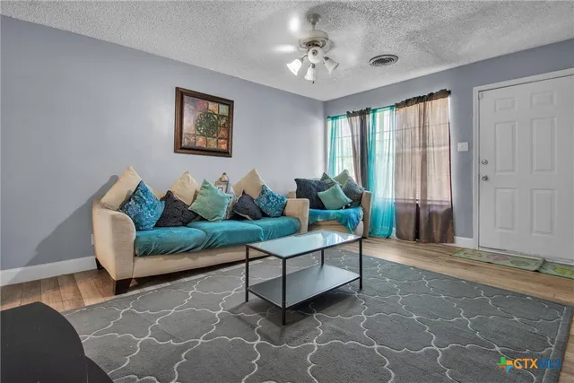 a living room with furniture and a potted plant