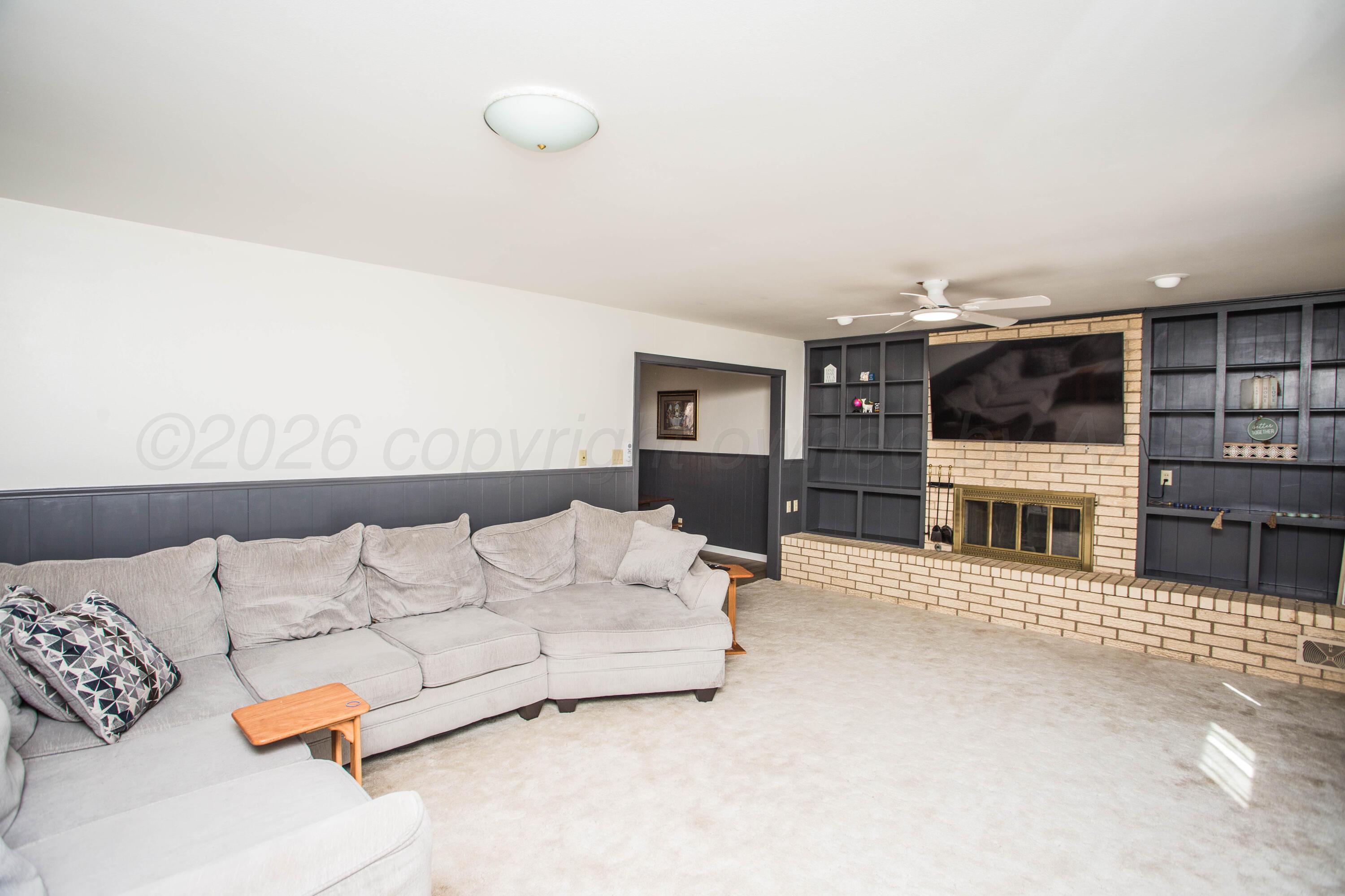 73 Houston Road Tulia, TX 79088 - Photo 13 of 55 a living room with furniture window and a flat screen tv
