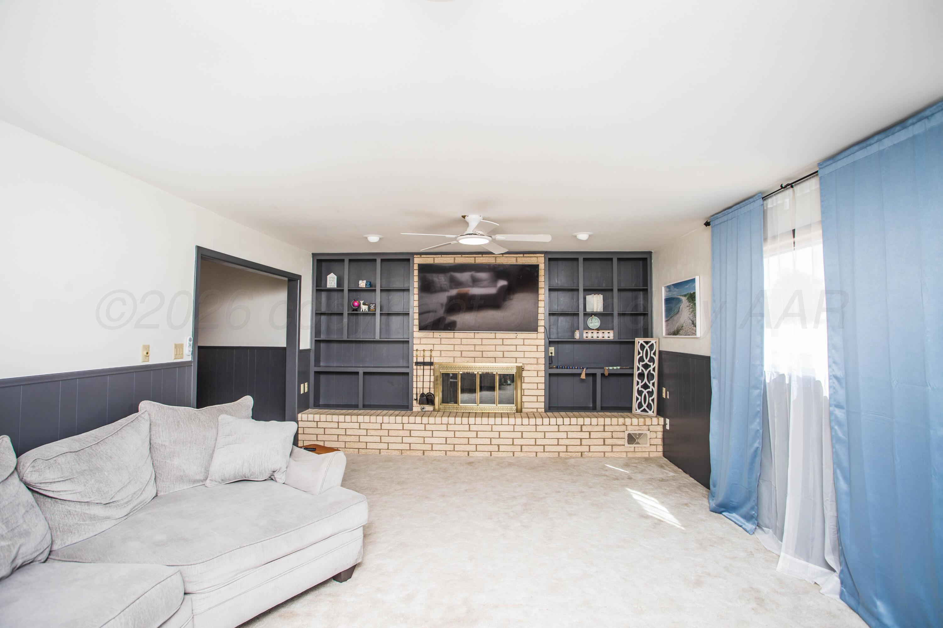 73 Houston Road Tulia, TX 79088 - Photo 14 of 55 a living room with furniture and a fireplace
