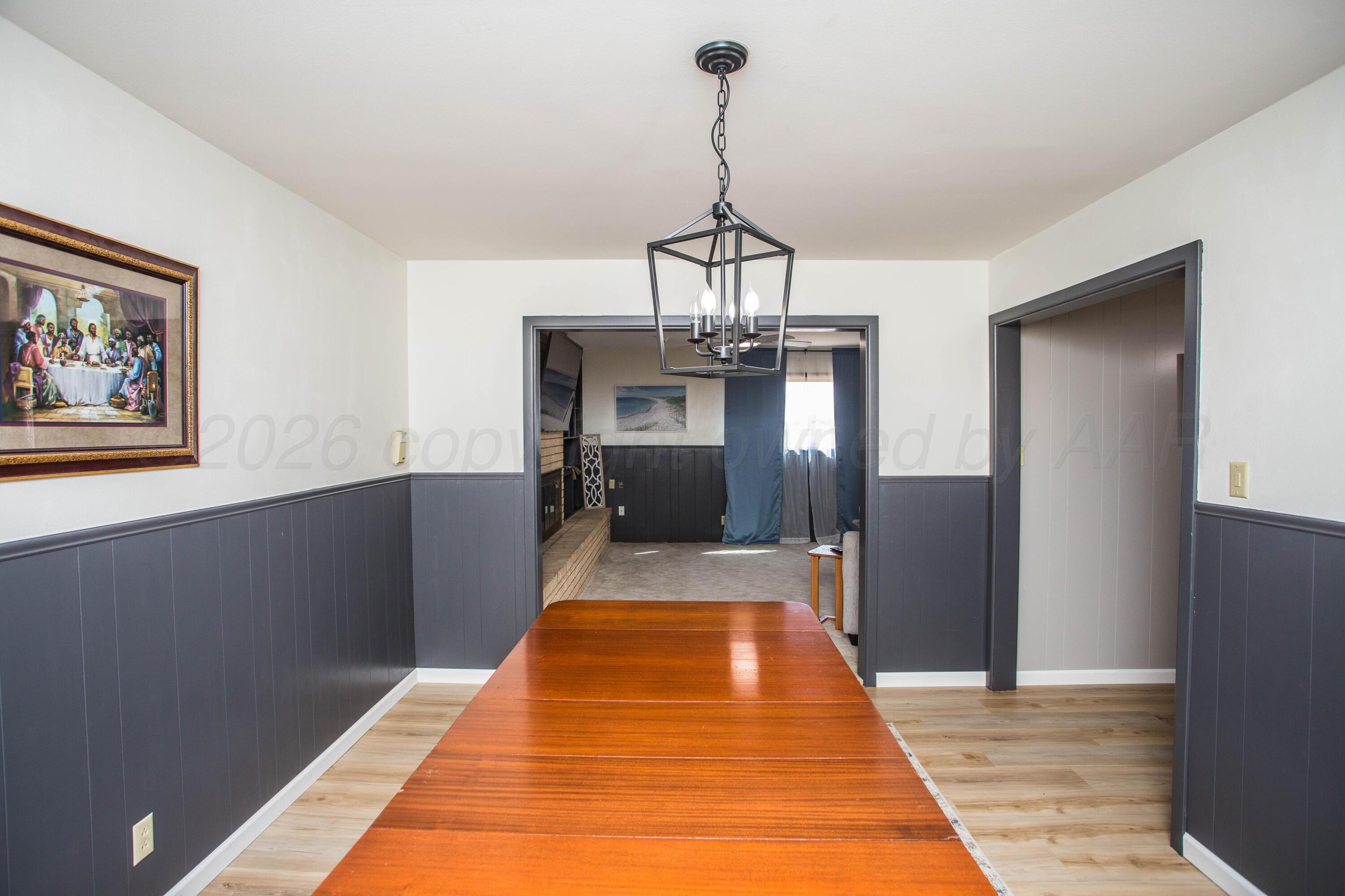 73 Houston Road Tulia, TX 79088 - Photo 15 of 55 a view of a room with a chandelier and wooden floor