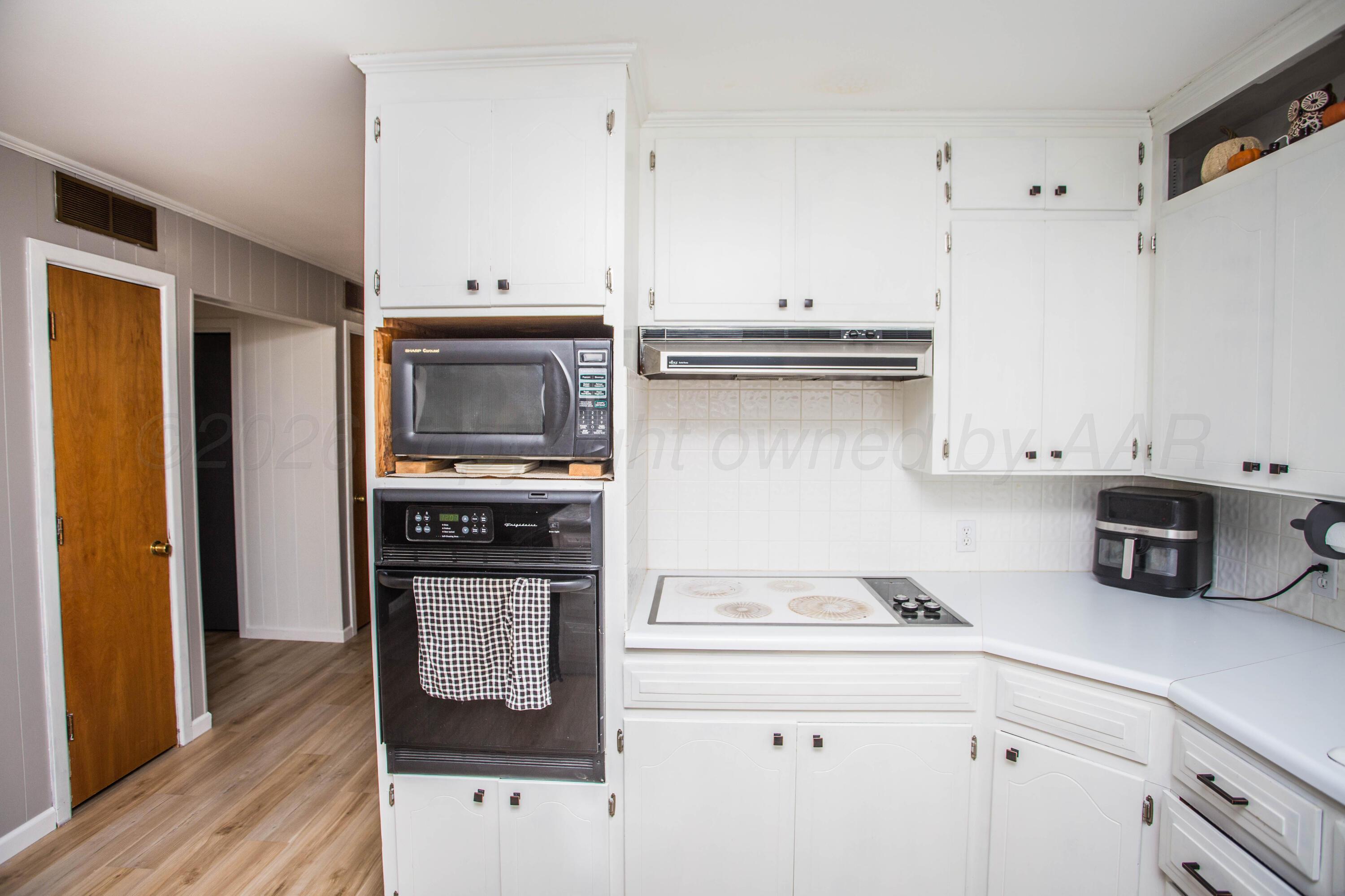 73 Houston Road Tulia, TX 79088 - Photo 20 of 55 a kitchen with granite countertop a sink cabinets and stainless steel appliances