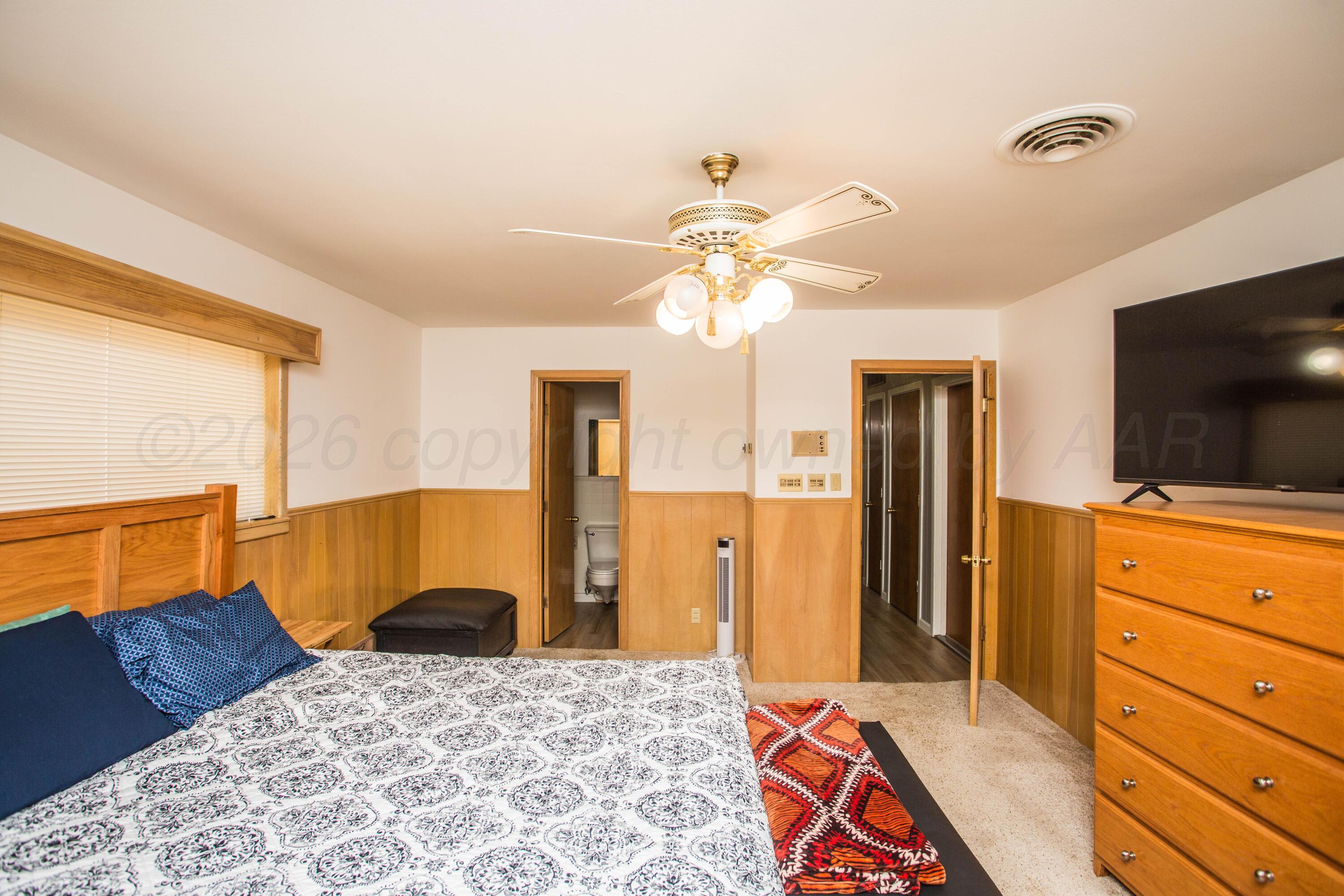 73 Houston Road Tulia, TX 79088 - Photo 27 of 55 a bedroom with a bed and a flat screen tv