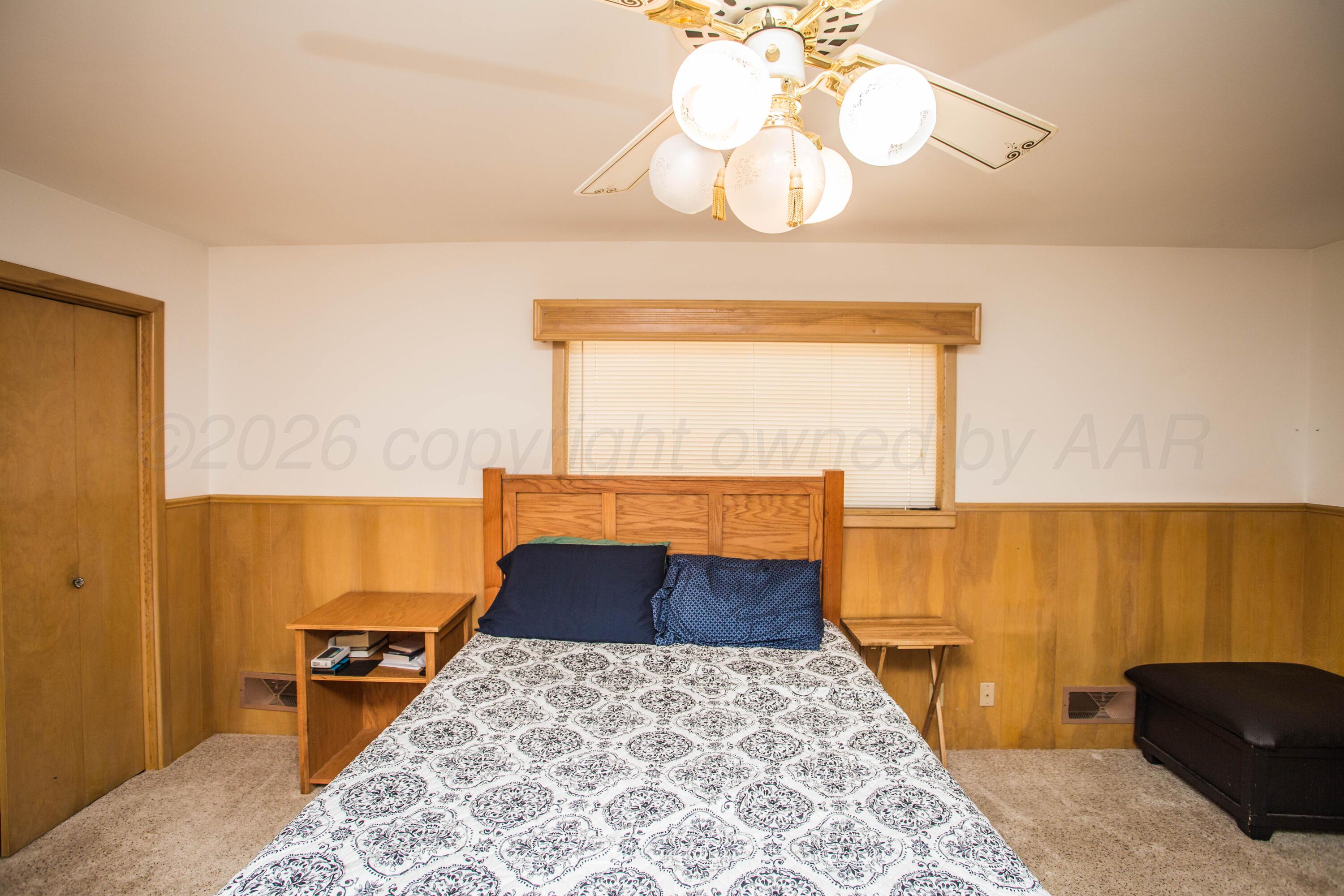 73 Houston Road Tulia, TX 79088 - Photo 28 of 55 a bedroom with a bed and wooden floor