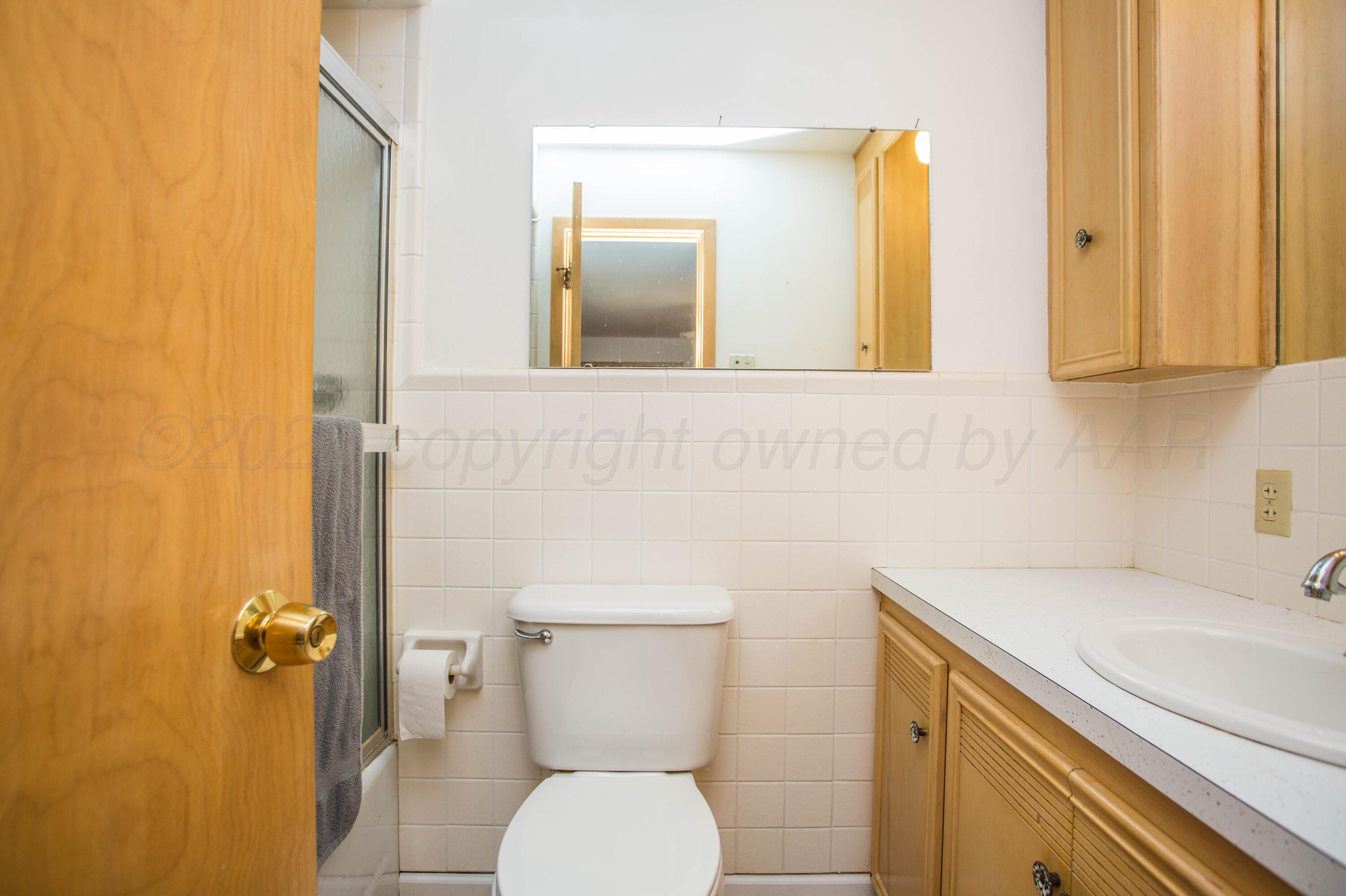 73 Houston Road Tulia, TX 79088 - Photo 30 of 55 a bathroom with a toilet sink and mirror