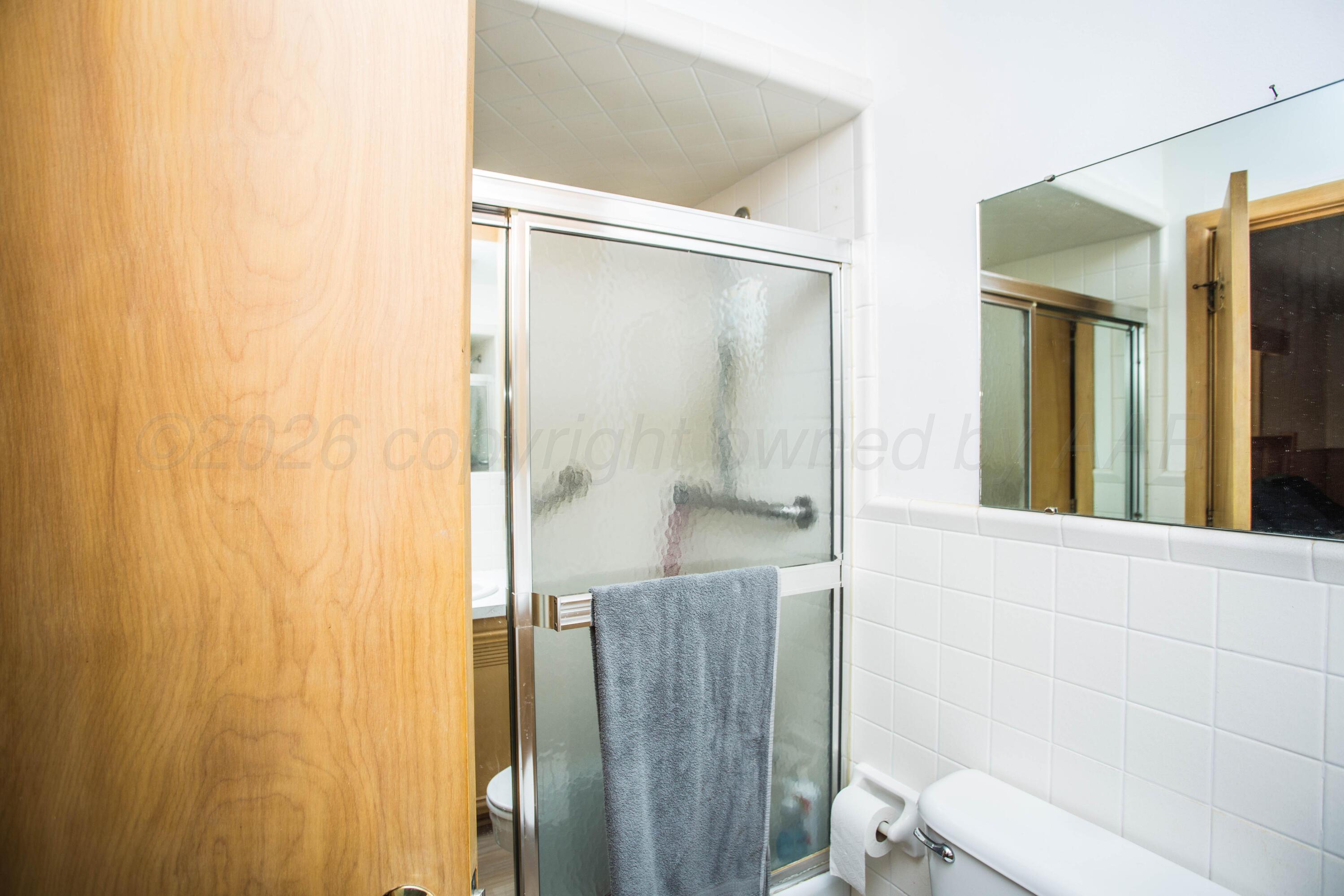 73 Houston Road Tulia, TX 79088 - Photo 31 of 55 a bathroom with a shower and a toilet