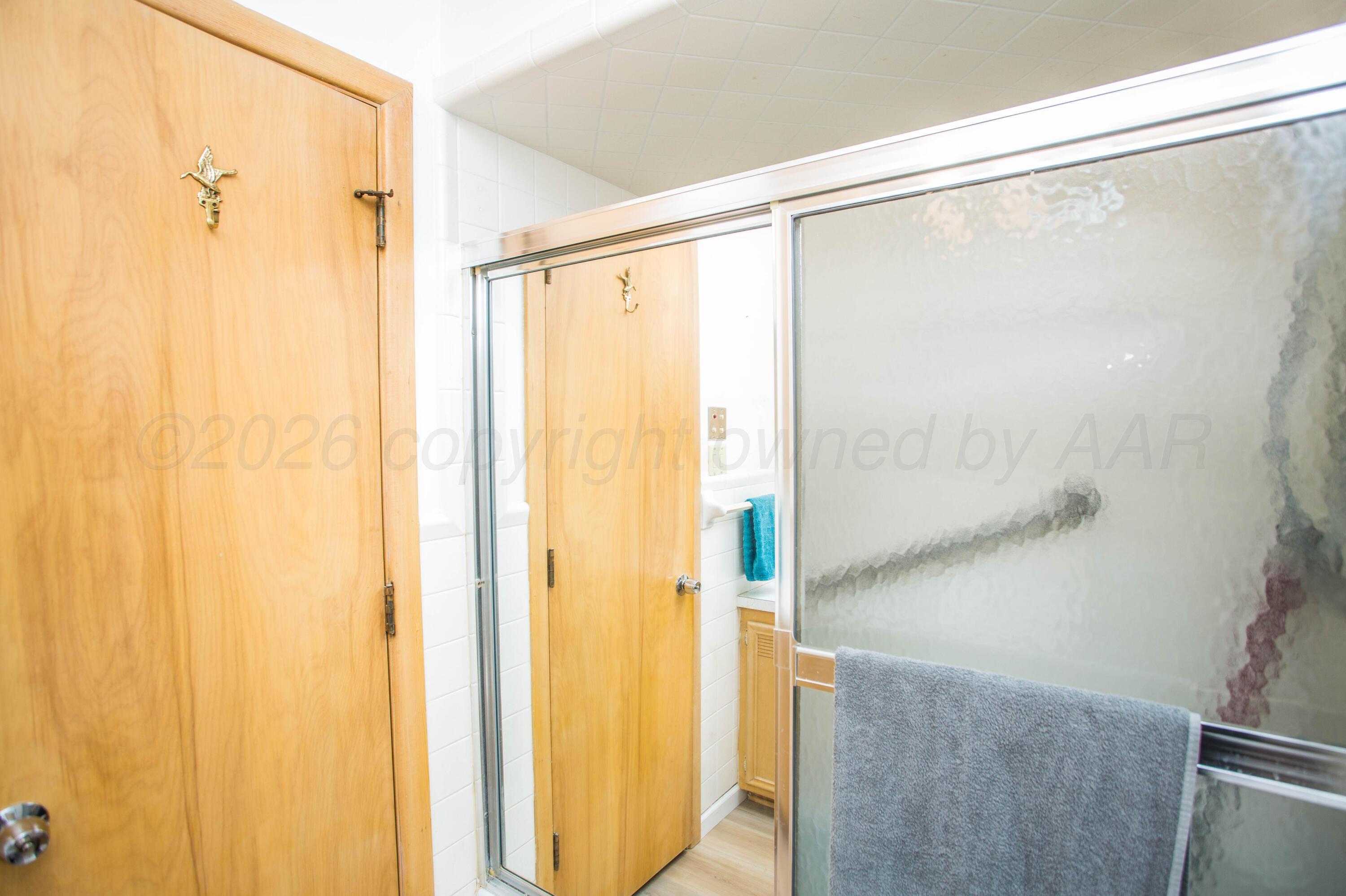 73 Houston Road Tulia, TX 79088 - Photo 32 of 55 a bathroom with a glass shower door