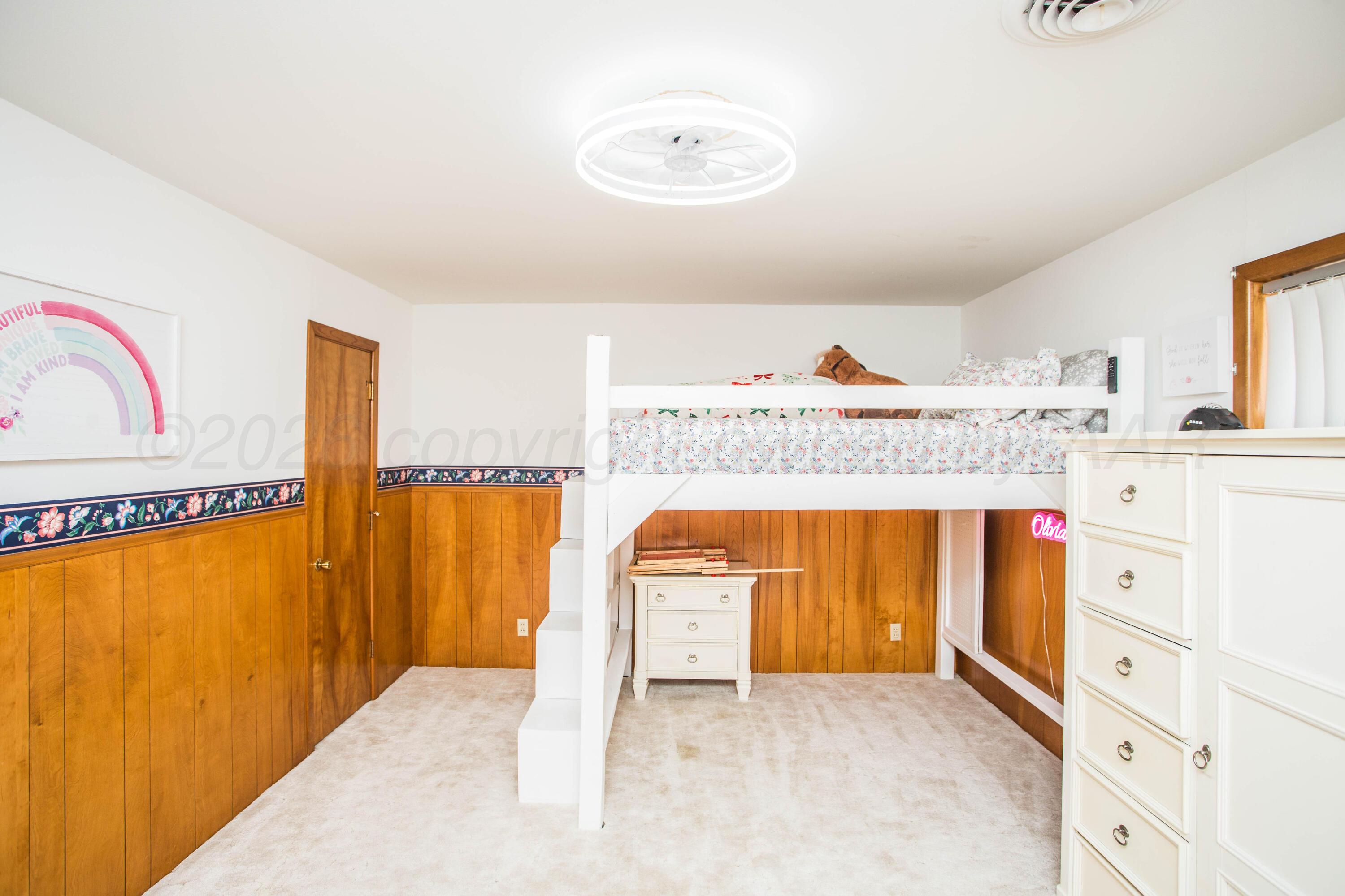 73 Houston Road Tulia, TX 79088 - Photo 43 of 55 a view of a bedroom with a bed and wooden floor
