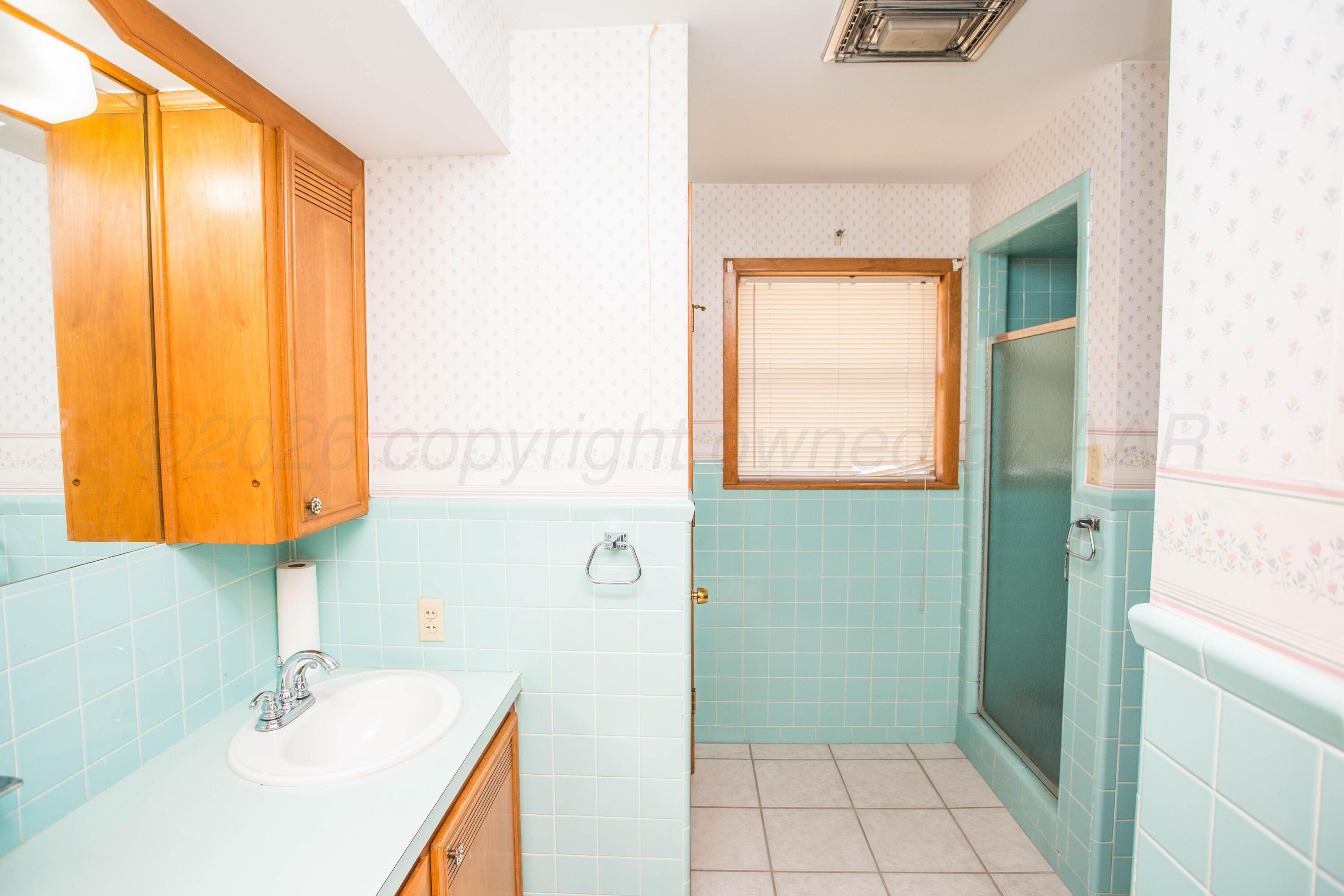 73 Houston Road Tulia, TX 79088 - Photo 45 of 55 a bathroom with a sink a toilet and a mirror