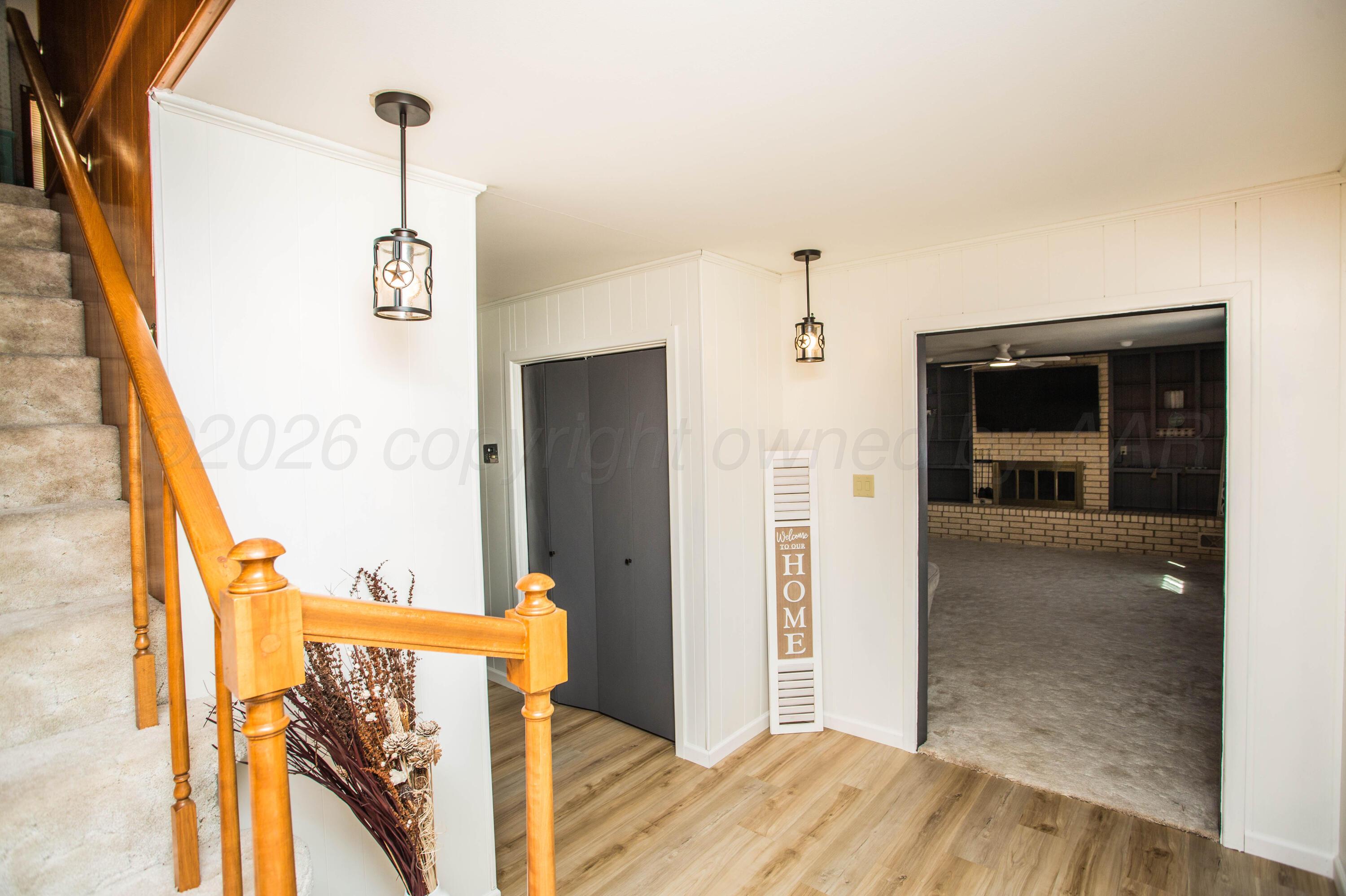 73 Houston Road Tulia, TX 79088 - Photo 9 of 55 a view of a hallway with wooden floor and staircase
