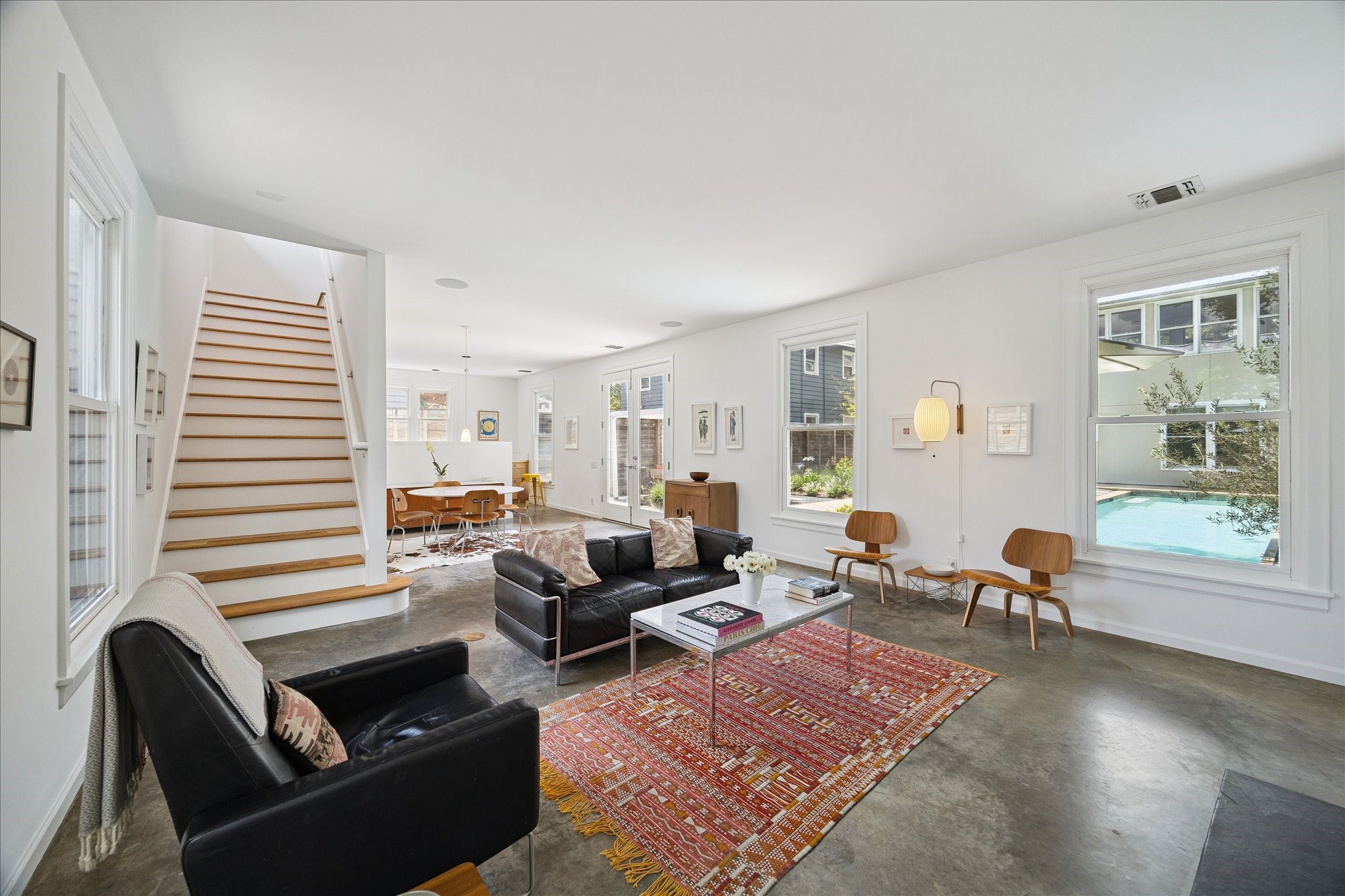 1418 Kipling Street Houston, TX 77006 - Photo 9 of 42 The abundance of windows brings the outdoors in from every vantage point. The concrete floors on the first level of both buildings, and the beautifully painted bight white walls are reminiscent of a gallery space.