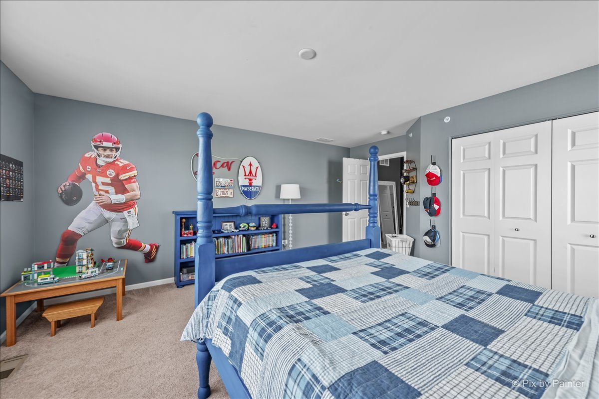 16207 West Switch Grass Road Lockport, IL 60441 - Photo 23 of 45 a bed room with a bed and a table