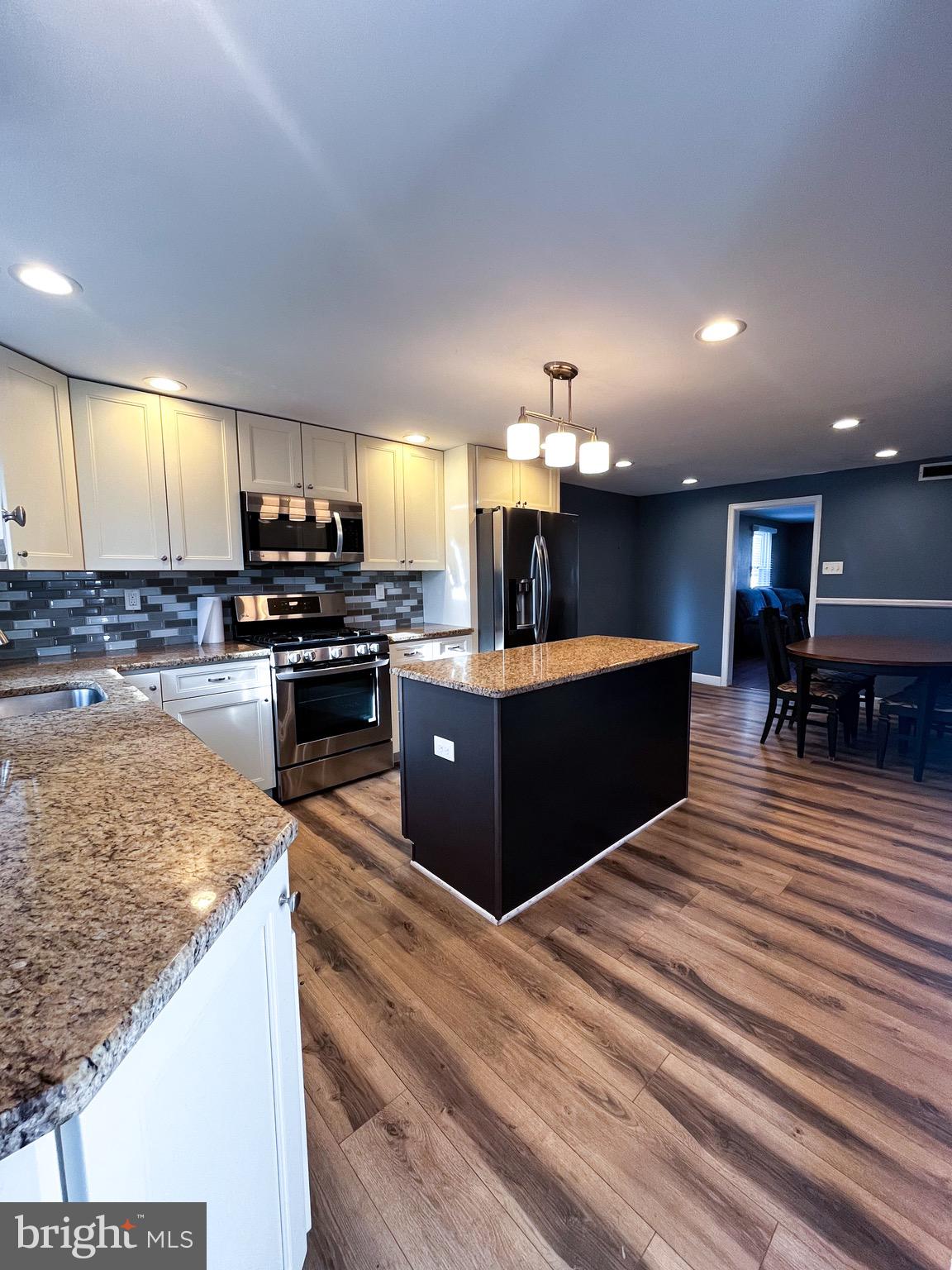 2314 Triebel Road Abington, PA 19001 - Photo 5 of 16 a kitchen with stainless steel appliances kitchen island granite countertop a stove and a sink