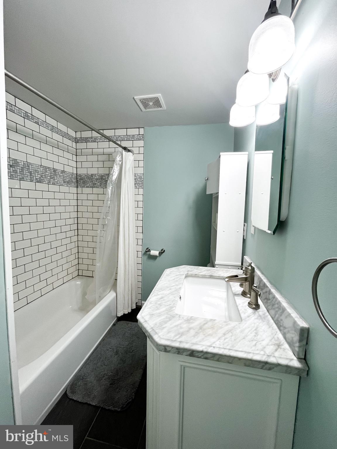 2314 Triebel Road Abington, PA 19001 - Photo 6 of 16 a bathroom with a granite countertop sink a toilet a mirror and bathtub