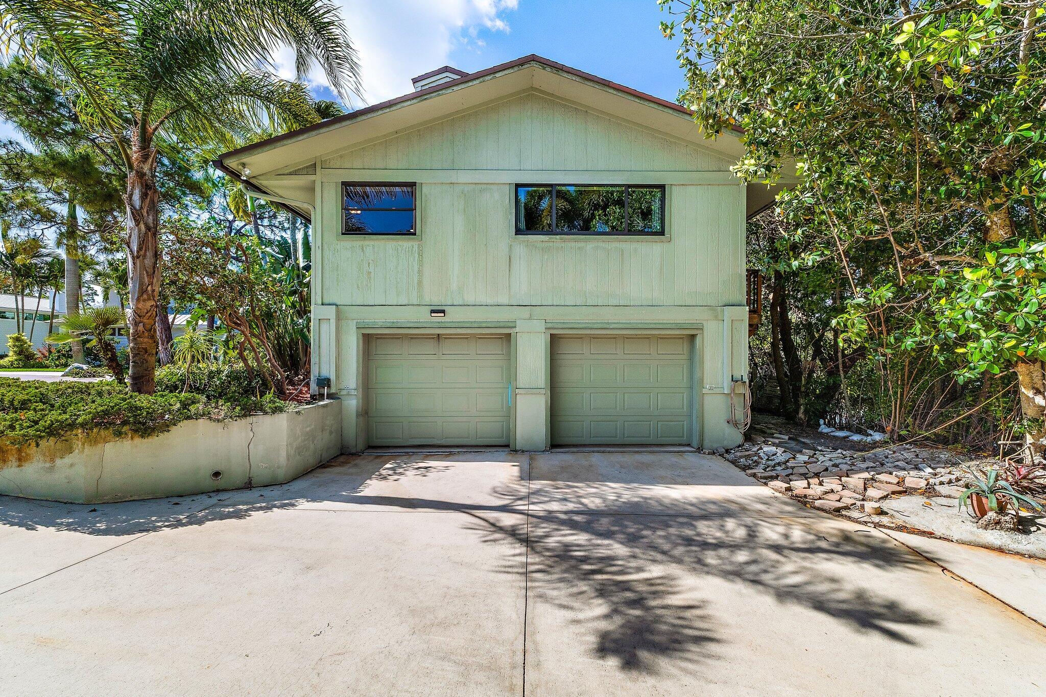 702 Warren Drive Jupiter, FL 33458 - Photo 64 of 76 a front view of a house with a yard