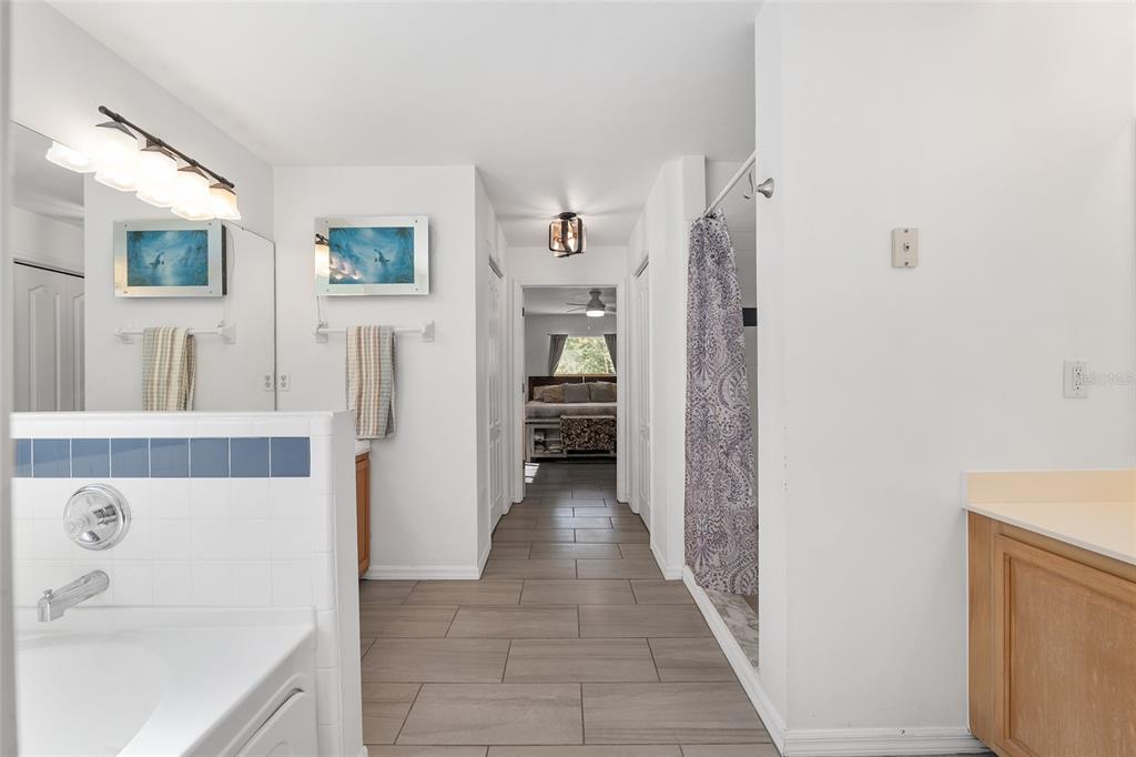 9128 Northwest 238 Street Alachua, FL 32615 - Photo 18 of 32 a view of a hallway with furniture and wooden floor