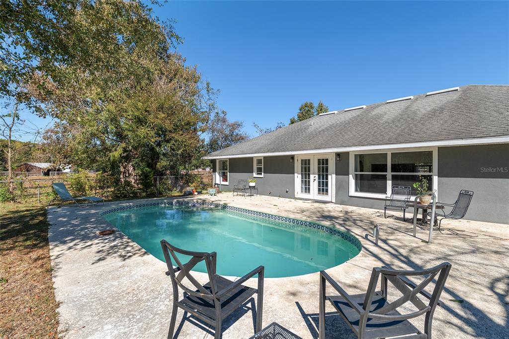 9128 Northwest 238 Street Alachua, FL 32615 - Photo 22 of 32 a view of a house with swimming pool and sitting area