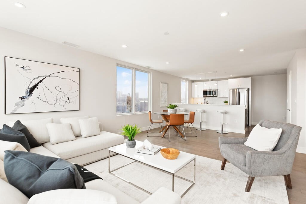 398 Cambridge Street, Unit 502 Boston, MA 02134 - Photo 2 of 11 a living room with furniture and kitchen view