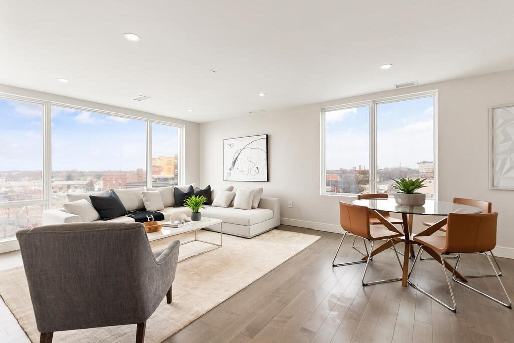398 Cambridge Street, Unit 502 Boston, MA 02134 - Photo 3 of 11 a living room with furniture and a large window