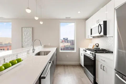 a kitchen that has a sink a stove and window