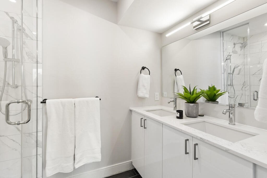 398 Cambridge Street, Unit 502 Boston, MA 02134 - Photo 6 of 11 a bathroom with a sink and a mirror