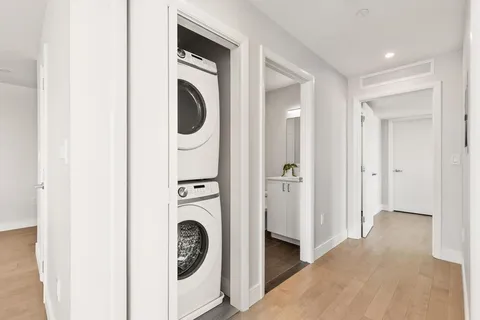 a view of a hallway with washer and dryer