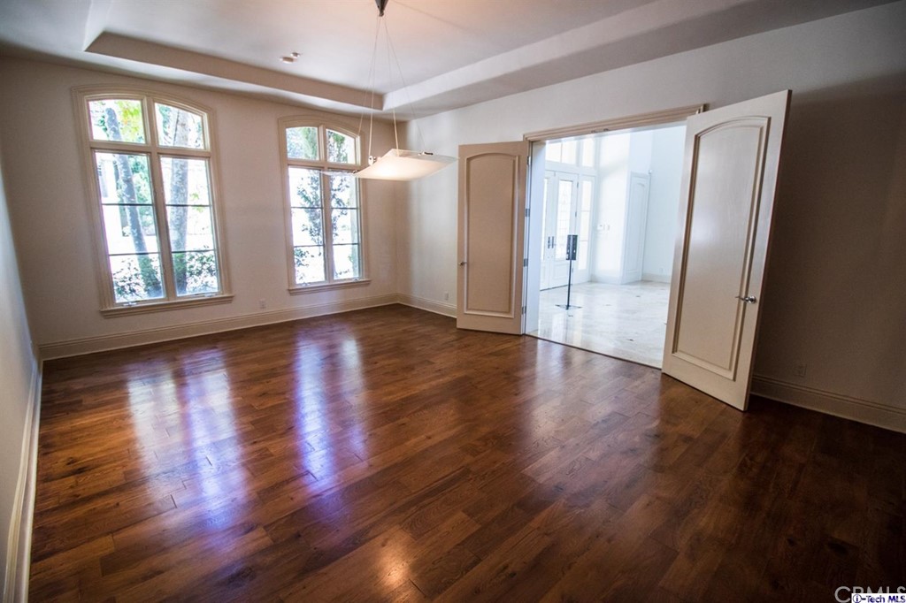 12801 Chalon Road Los Angeles, CA 90049 - Photo 18 of 77 a view of an empty room with wooden floor and a window