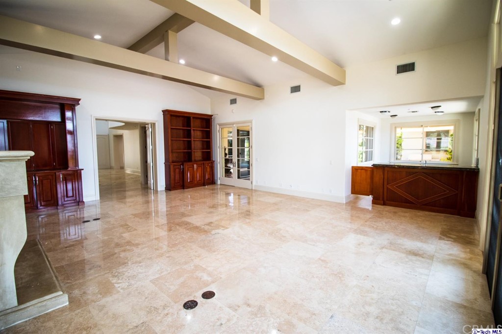 12801 Chalon Road Los Angeles, CA 90049 - Photo 20 of 77 an empty room with chandelier and windows