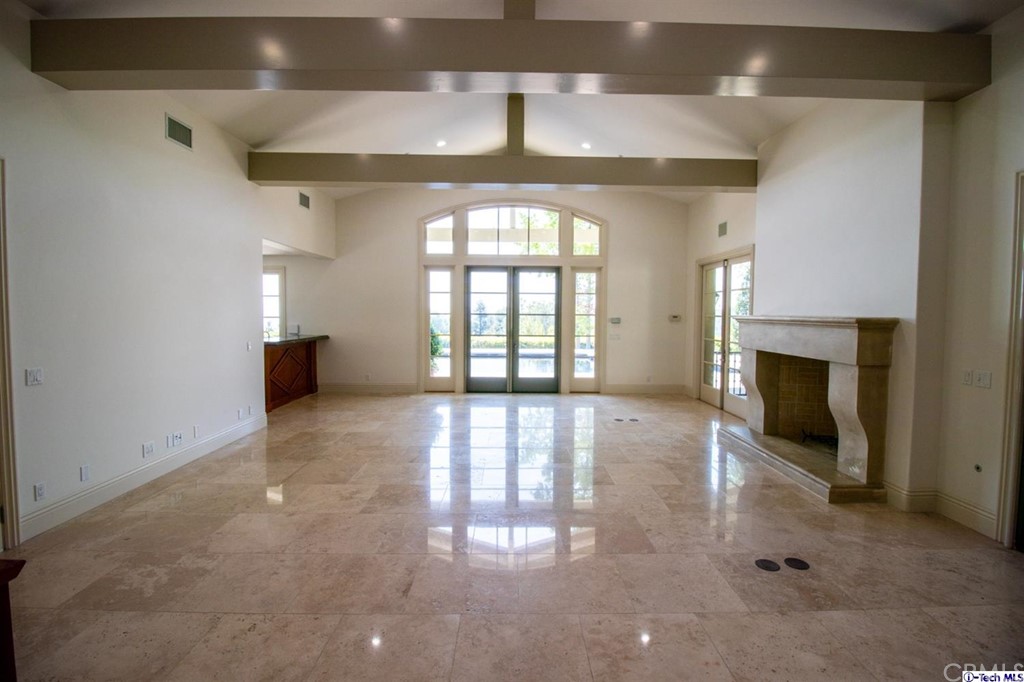 12801 Chalon Road Los Angeles, CA 90049 - Photo 21 of 77 an empty room with windows and fireplace