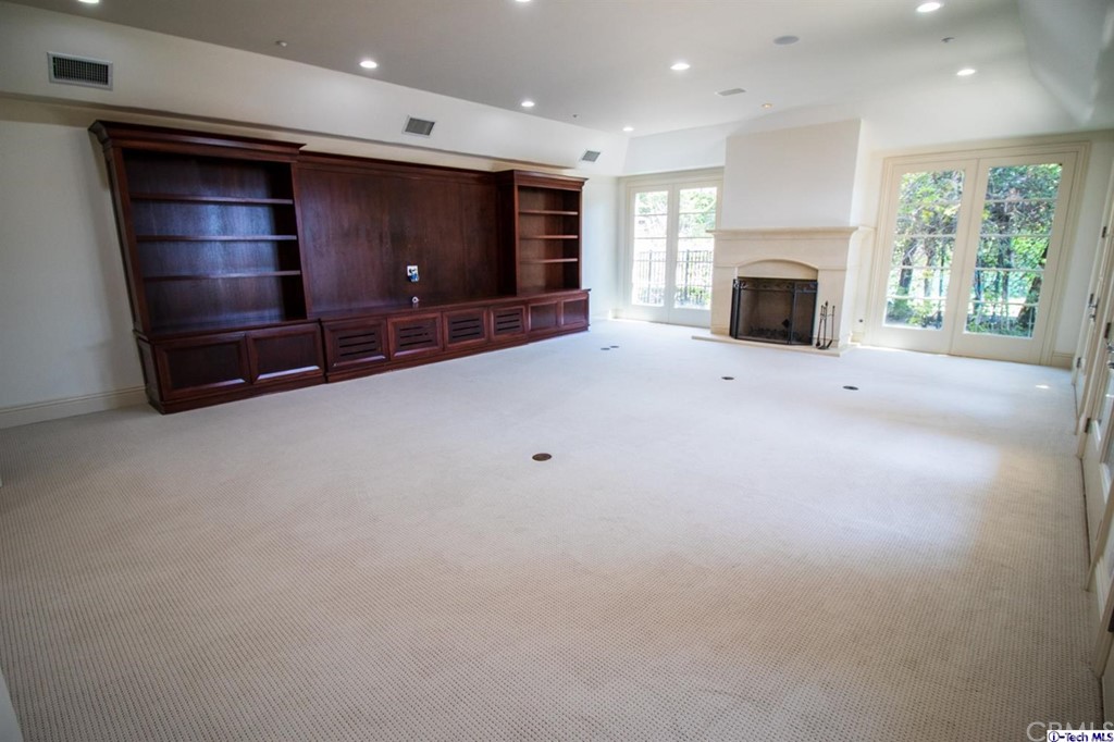 12801 Chalon Road Los Angeles, CA 90049 - Photo 26 of 77 a view of empty room with a fireplace
