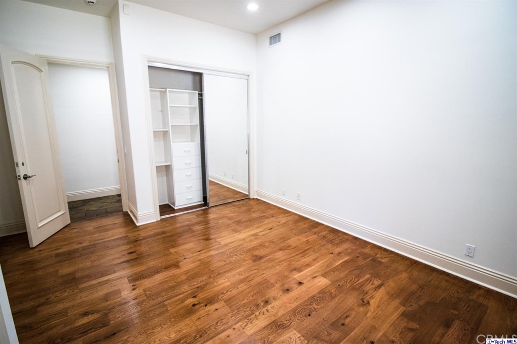 12801 Chalon Road Los Angeles, CA 90049 - Photo 29 of 77 an empty room with wooden floor and closet