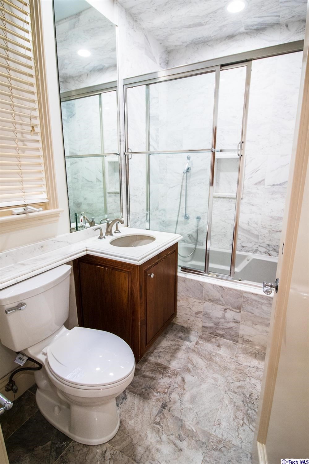 12801 Chalon Road Los Angeles, CA 90049 - Photo 30 of 77 a bathroom with a sink a toilet and tub