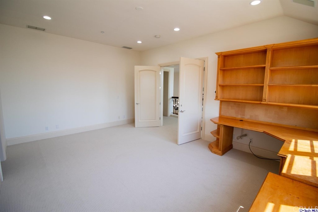12801 Chalon Road Los Angeles, CA 90049 - Photo 41 of 77 a view of an empty room with a cabinet and a window