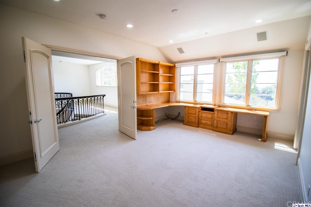 12801 Chalon Road Los Angeles, CA 90049 - Photo 42 of 77 a view of an empty room with a fireplace and a large window