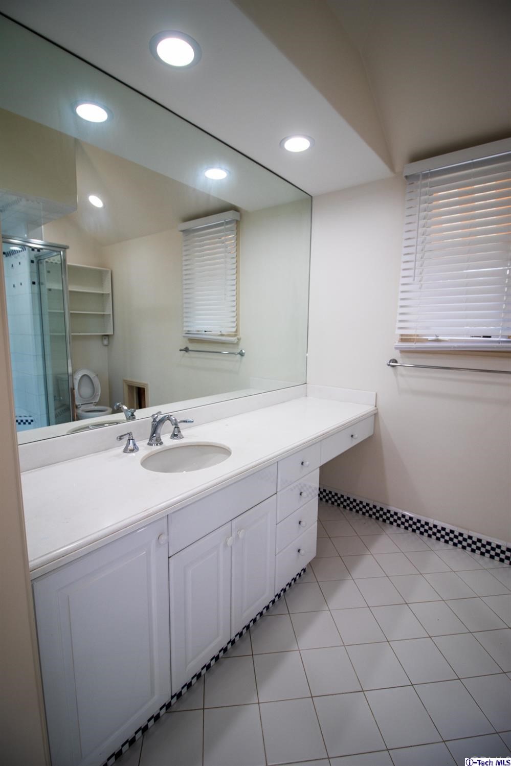 12801 Chalon Road Los Angeles, CA 90049 - Photo 43 of 77 a bathroom with a sink double vanity and mirror