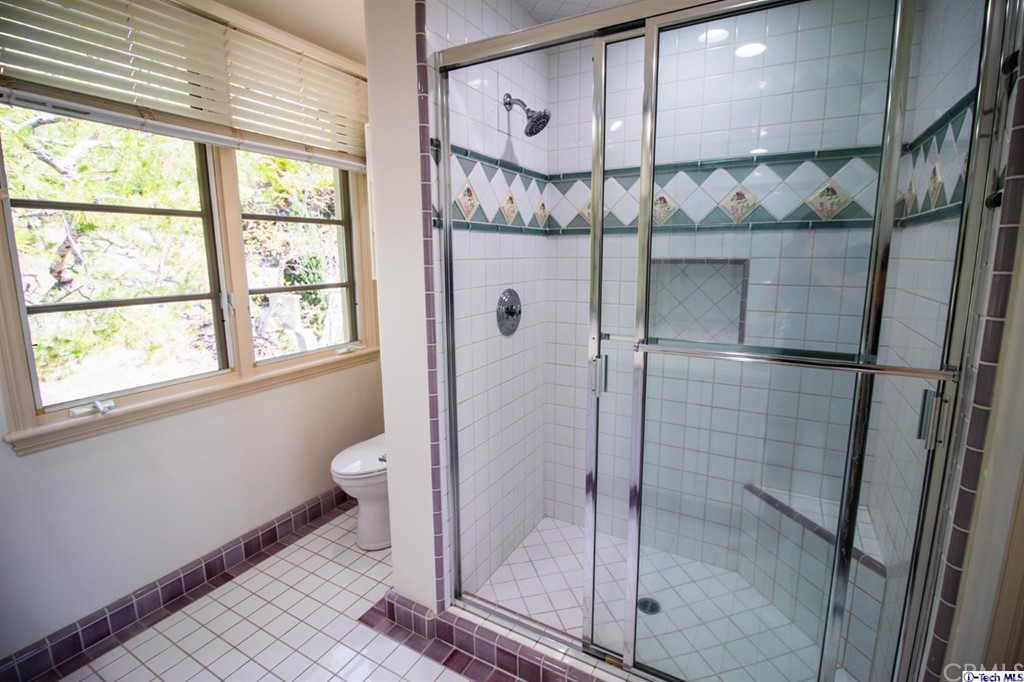 12801 Chalon Road Los Angeles, CA 90049 - Photo 49 of 77 a bathroom with a shower and a toilet