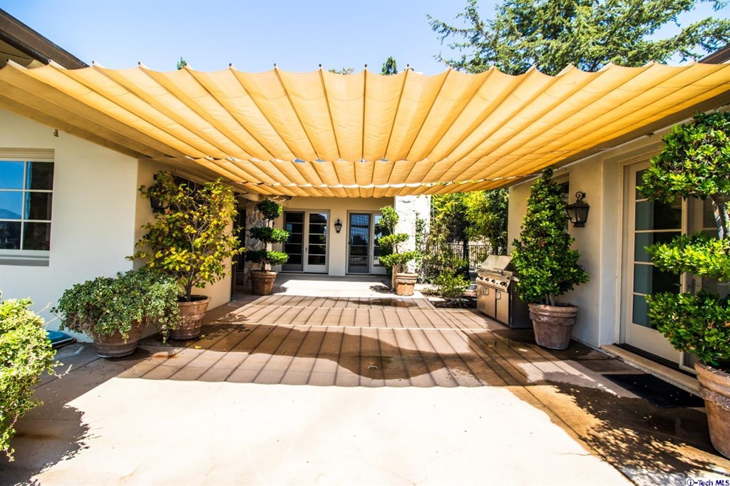 12801 Chalon Road Los Angeles, CA 90049 - Photo 63 of 77 a view of a house with backyard and sitting area