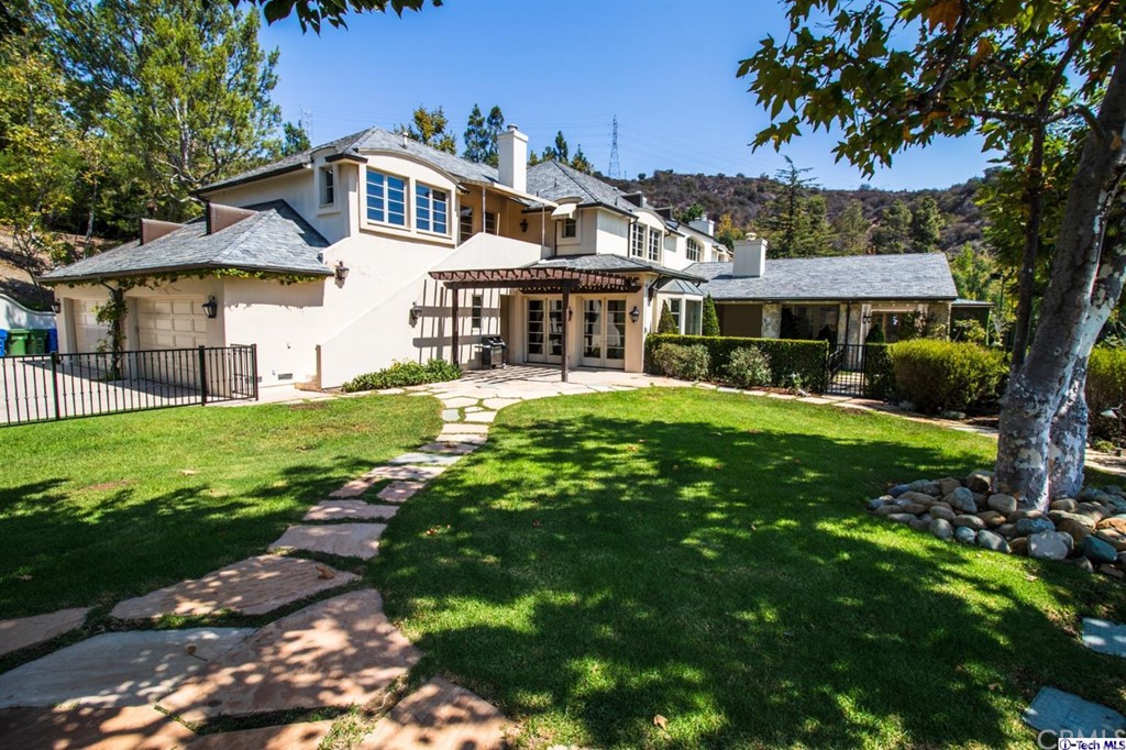 12801 Chalon Road Los Angeles, CA 90049 - Photo 67 of 77 a front view of a house with yard and green space