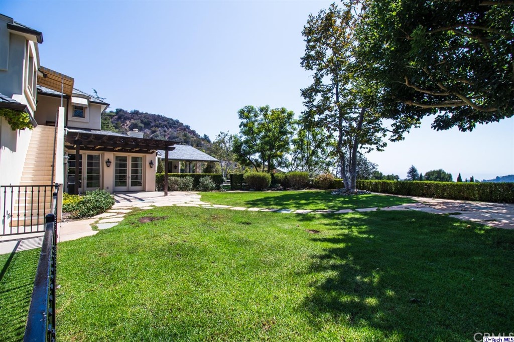 12801 Chalon Road Los Angeles, CA 90049 - Photo 70 of 77 a front view of house with yard and green space