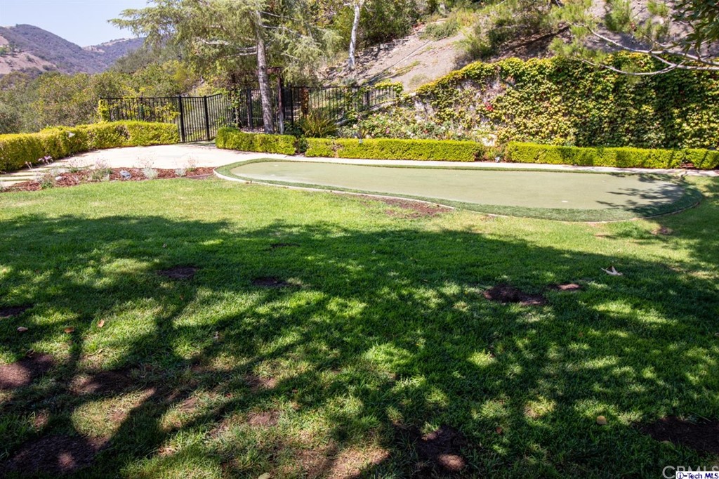 12801 Chalon Road Los Angeles, CA 90049 - Photo 71 of 77 a view of swimming pool with an outdoor space and seating area