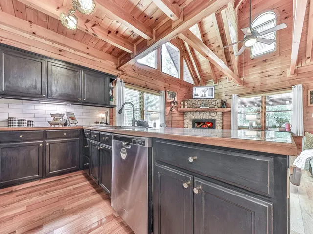 a kitchen with stainless steel appliances granite countertop a sink stove and cabinets