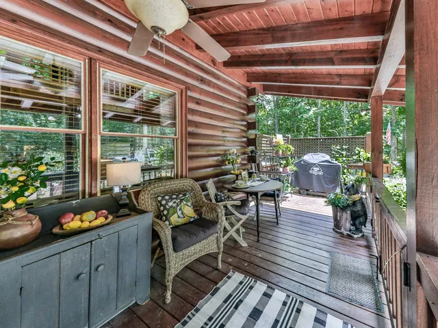 a view of a brick house with a yard and large trees