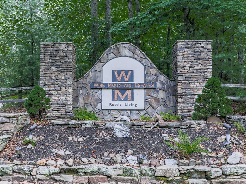 34 Amber Way Morganton, GA 30560 - Photo 37 of 39 a view of a brick house with a yard and large trees